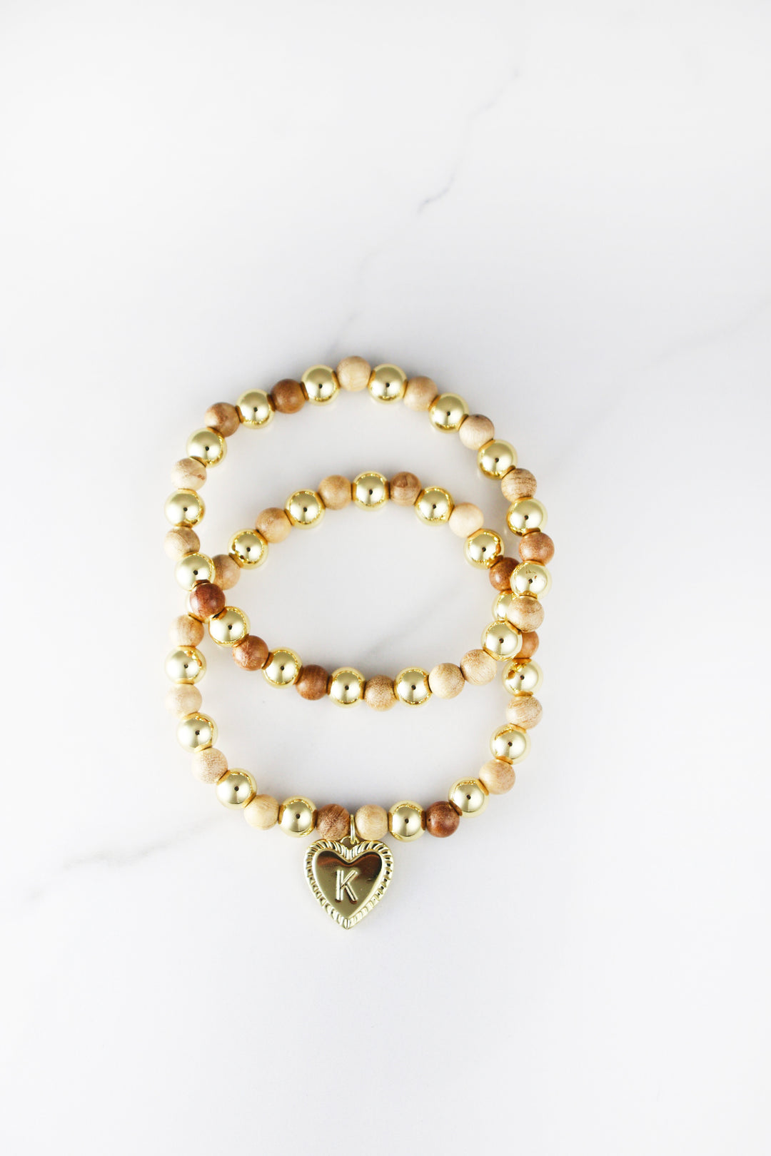 Beaded initial bracelet for women, customizable and affordable fashion jewelry featuring gold accents and letter beads, perfect for stacking or gifting.
