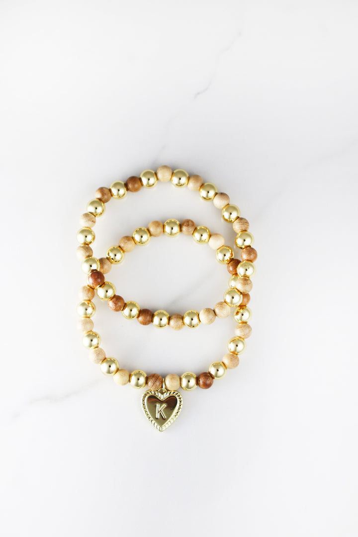 Beaded initial bracelet for women, customizable and affordable fashion jewelry featuring gold accents and letter beads, perfect for stacking or gifting.