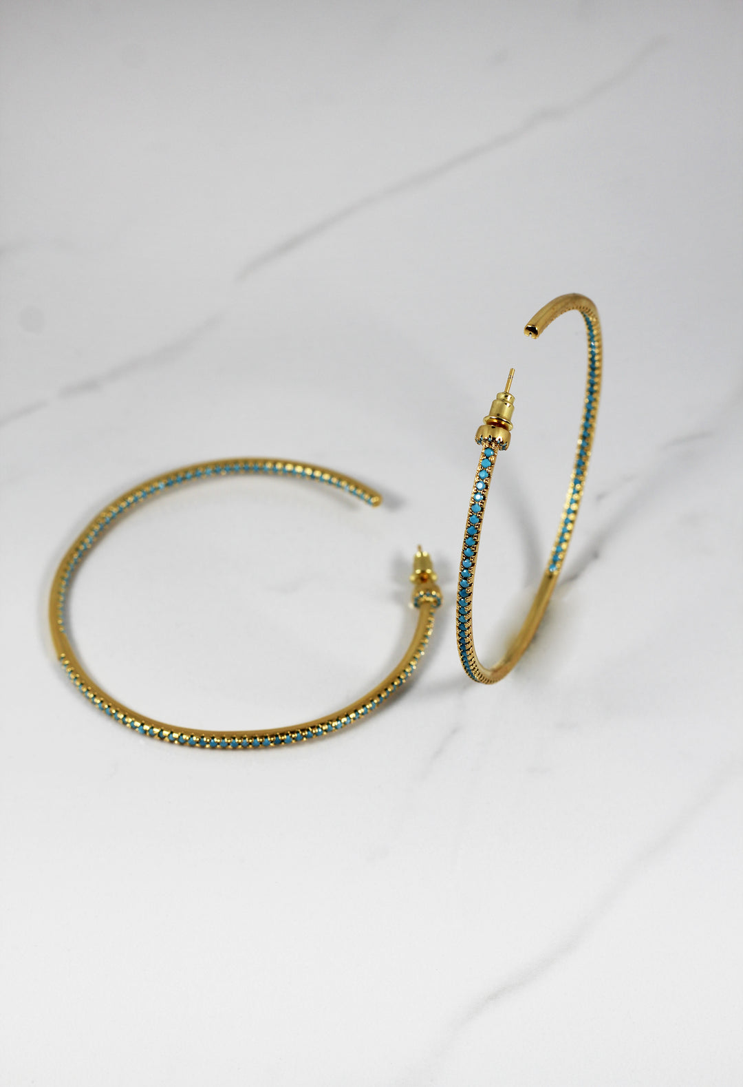 Gold plated hoop earrings with CZ stones, sparkling and lightweight fashion jewelry for women, perfect for adding a flirty touch to everyday or night-out looks.
