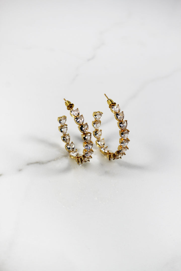 Gold plated heart hoop earrings with CZ stones, sparkling and lightweight fashion jewelry for women, perfect for adding a flirty touch to everyday or night-out looks.