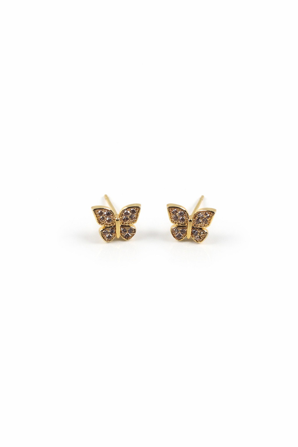 Gold butterfly earrings with cz gemstones on a white background