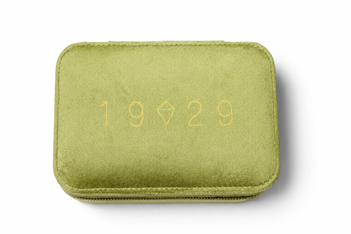 Green case with '1929' embossed on a white background